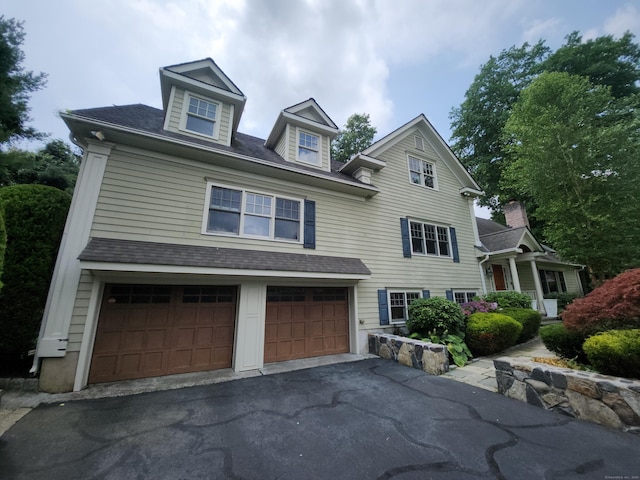 8 Caddy Rd, Norwalk, CT 06851 - view of front of house with a garage, asphalt driveway, and a shingled roof