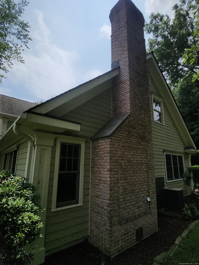 8 Caddy Rd, Norwalk, CT 06851 - view of home's exterior featuring a chimney and brick siding