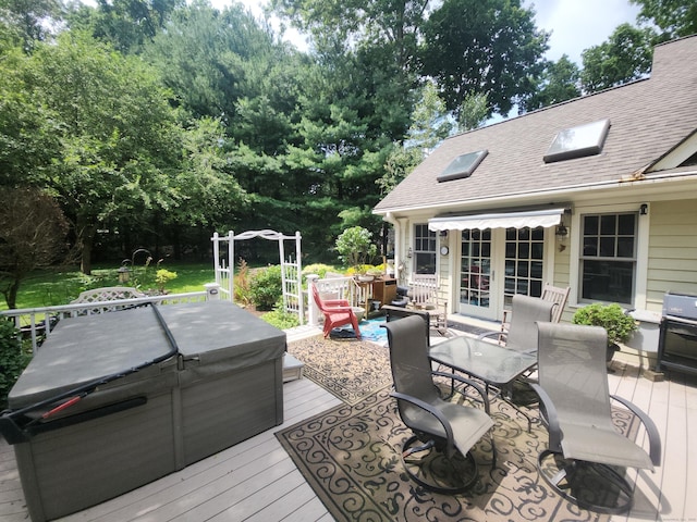 8 Caddy Rd, Norwalk, CT 06851 - wooden deck featuring a hot tub, outdoor dining space, view of scattered trees, and a grill