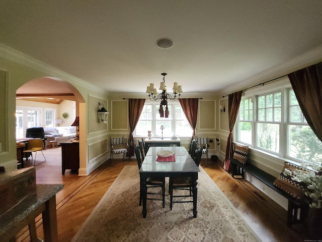 8 Caddy Rd, Norwalk, CT 06851 - dining space with a chandelier, healthy amount of natural light, ornamental molding, arched walkways, and a decorative wall