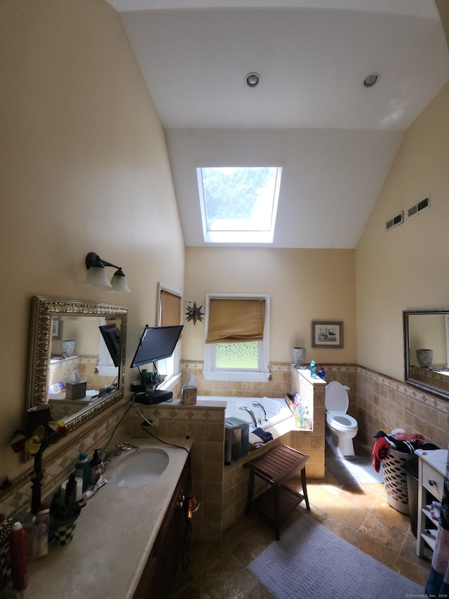8 Caddy Rd, Norwalk, CT 06851 - full bathroom featuring tile walls, a skylight, a garden tub, wainscoting, and vanity