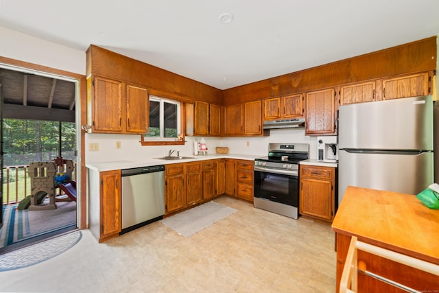 15 Revere Rd, Washington, CT 06793 - kitchen with stainless steel appliances, under cabinet range hood, light countertops, and brown cabinets