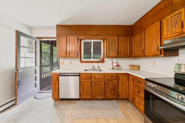 15 Revere Rd, Washington, CT 06793 - kitchen with appliances with stainless steel finishes, under cabinet range hood, a baseboard heating unit, light countertops, and brown cabinets