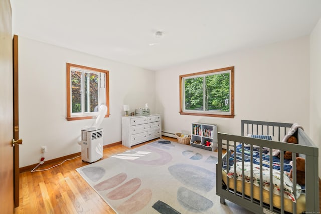 15 Revere Rd, Washington, CT 06793 - bedroom with light wood-style floors and a crib