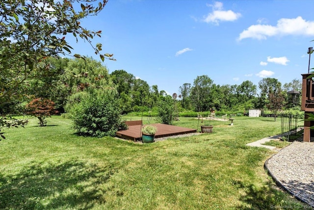 367 Pine Hill Rd, Sterling, CT 06377 - view of green lawn with a storage unit and a wooden deck