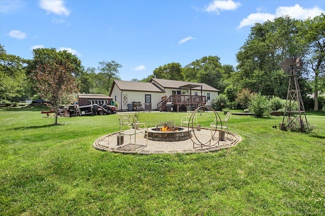 367 Pine Hill Rd, Sterling, CT 06377 - view of green lawn featuring a fire pit and a wooden deck