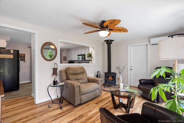 367 Pine Hill Rd, Sterling, CT 06377 - living area featuring a wood stove, light wood-style flooring, and a ceiling fan