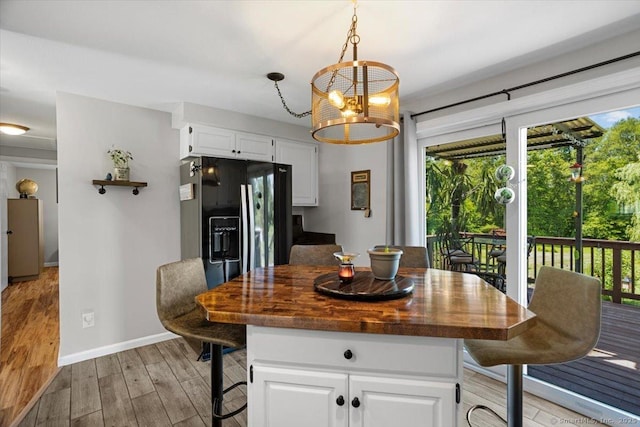 367 Pine Hill Rd, Sterling, CT 06377 - kitchen with healthy amount of natural light, light wood finished floors, and a kitchen bar