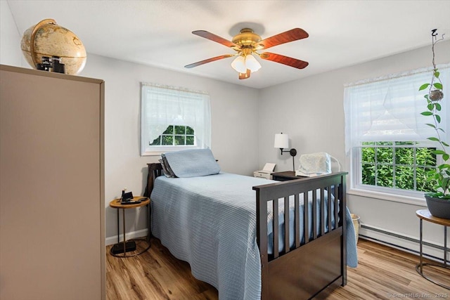 367 Pine Hill Rd, Sterling, CT 06377 - bedroom with multiple windows, wood finished floors, a baseboard heating unit, and ceiling fan