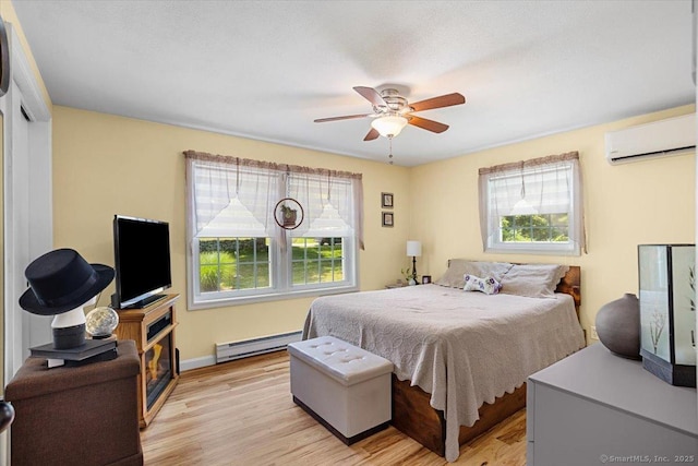 367 Pine Hill Rd, Sterling, CT 06377 - bedroom featuring a wall mounted air conditioner, multiple windows, a baseboard radiator, and light wood-style flooring
