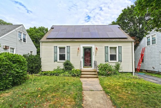205 Lee St, West Haven, CT 06516 - view of front facade featuring solar panels, a front lawn, and a shingled roof