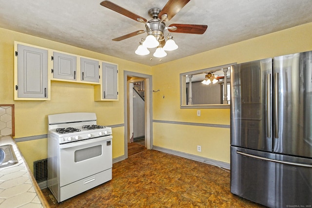 205 Lee St, West Haven, CT 06516 - kitchen featuring freestanding refrigerator, white range with gas stovetop, tile counters, and ceiling fan