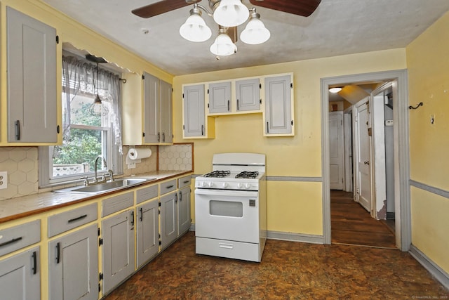 205 Lee St, West Haven, CT 06516 - kitchen featuring white gas stove, ceiling fan, tasteful backsplash, and tile countertops
