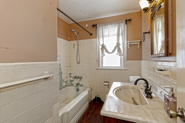 205 Lee St, West Haven, CT 06516 - bathroom with tile walls, washtub / shower combination, wood finished floors, wainscoting, and vanity