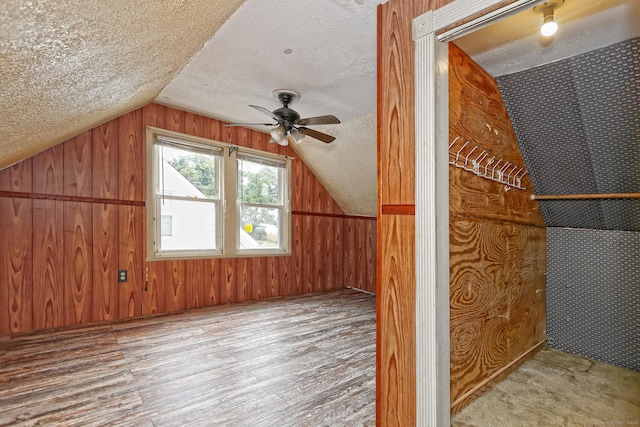 205 Lee St, West Haven, CT 06516 - bonus room featuring a textured ceiling, wood finished floors, vaulted ceiling, wooden walls, and a ceiling fan