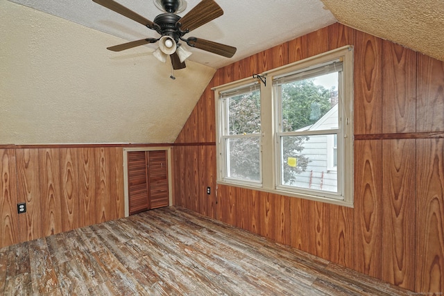 205 Lee St, West Haven, CT 06516 - bonus room with vaulted ceiling, a textured ceiling, wooden walls, wood finished floors, and a ceiling fan