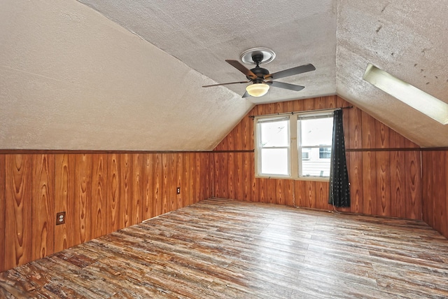 205 Lee St, West Haven, CT 06516 - bonus room featuring wood-type flooring, a textured ceiling, wooden walls, vaulted ceiling, and ceiling fan