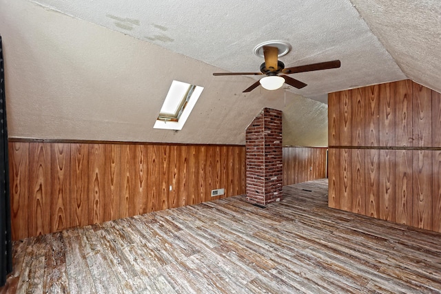 205 Lee St, West Haven, CT 06516 - additional living space featuring a skylight, wood finished floors, lofted ceiling, wood walls, and a ceiling fan