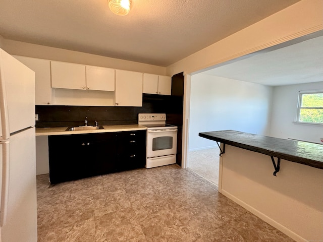 1730 State St Apt 306, Hamden, CT 06517 - kitchen with white appliances, white cabinetry, and tasteful backsplash