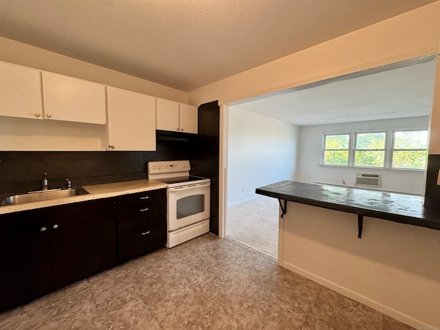 1730 State St Apt 306, Hamden, CT 06517 - kitchen featuring white electric range oven, a kitchen breakfast bar, white cabinets, a wall mounted AC, and decorative backsplash