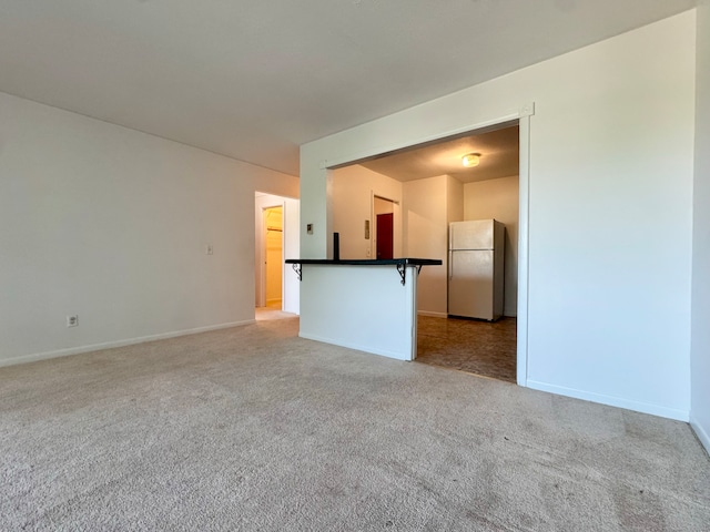 1730 State St Apt 306, Hamden, CT 06517 - unfurnished living room with light carpet and baseboards