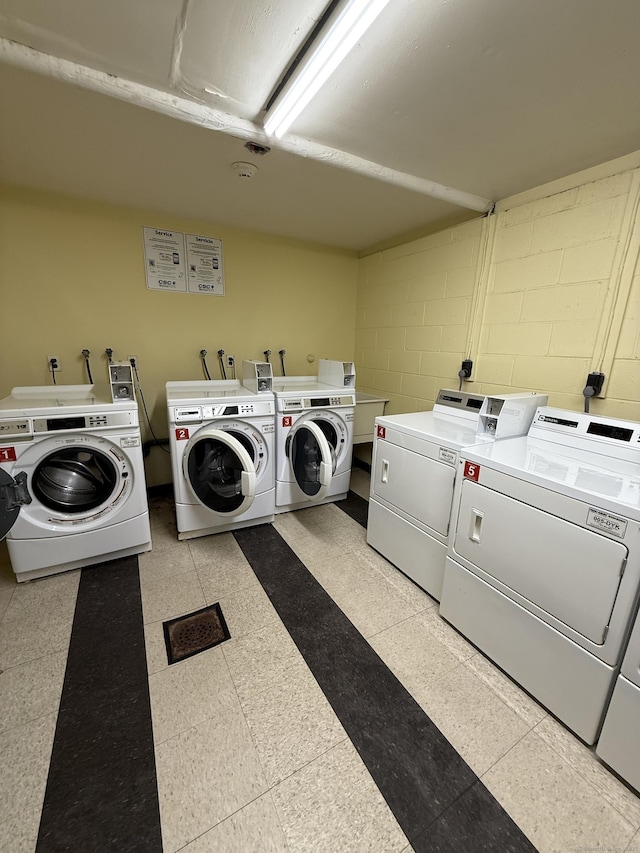 92 Wilton Crst, Wilton, CT 06897 - shared laundry room featuring washing machine and clothes dryer and concrete block wall