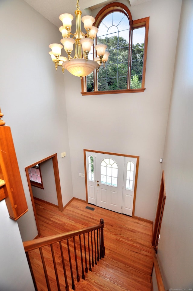 146 Pheasant Way S, Windsor, CT 06074 - foyer featuring a chandelier, a towering ceiling, wood finished floors, and healthy amount of natural light