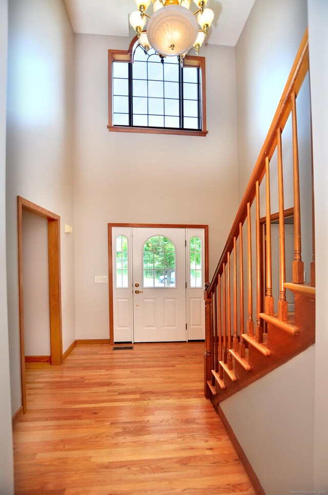 146 Pheasant Way S, Windsor, CT 06074 - foyer entrance featuring a towering ceiling, a chandelier, light wood-style floors, and stairs