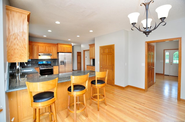 146 Pheasant Way S, Windsor, CT 06074 - kitchen with stainless steel appliances, a peninsula, light wood-style floors, under cabinet range hood, and decorative backsplash