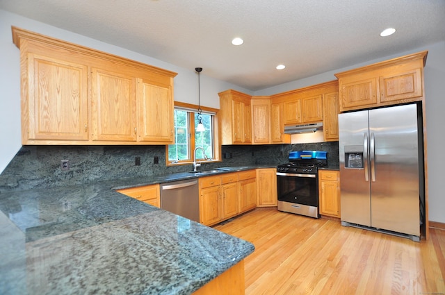 146 Pheasant Way S, Windsor, CT 06074 - kitchen with stainless steel appliances, under cabinet range hood, light wood-style floors, decorative light fixtures, and backsplash