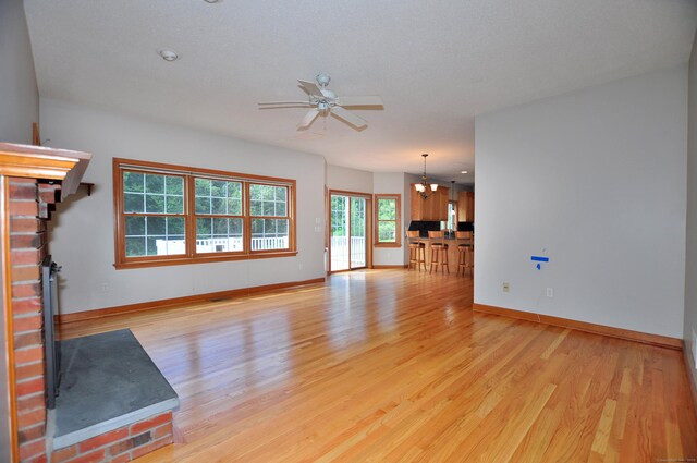 146 Pheasant Way S, Windsor, CT 06074 - unfurnished living room with light wood-style floors, a ceiling fan, and a chandelier