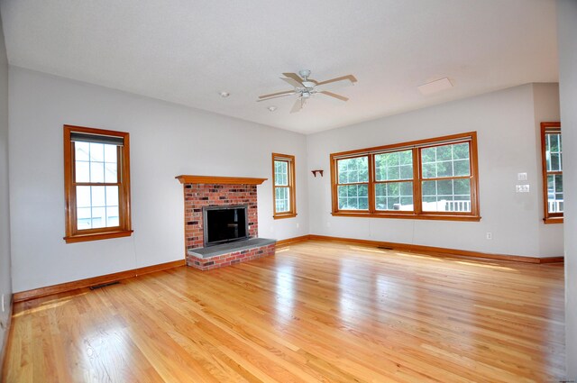 146 Pheasant Way S, Windsor, CT 06074 - unfurnished living room with light wood-type flooring, a ceiling fan, and a brick fireplace