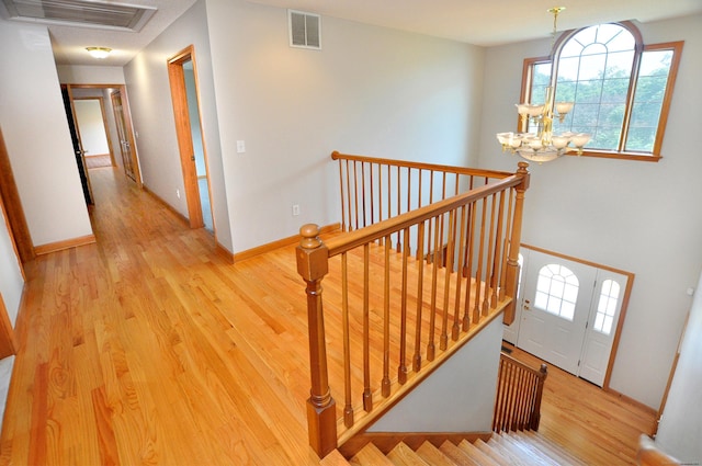 146 Pheasant Way S, Windsor, CT 06074 - stairway featuring wood finished floors and a chandelier