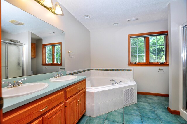 146 Pheasant Way S, Windsor, CT 06074 - bathroom with double vanity, a stall shower, a garden tub, tile patterned flooring, and recessed lighting