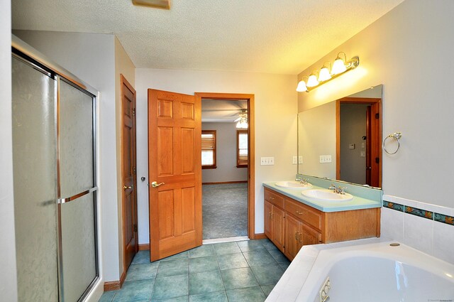 146 Pheasant Way S, Windsor, CT 06074 - bathroom with double vanity, a stall shower, a bath, a textured ceiling, and tile patterned floors