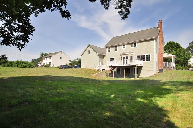 146 Pheasant Way S, Windsor, CT 06074 - rear view of house featuring a chimney, a lawn, and a wooden deck