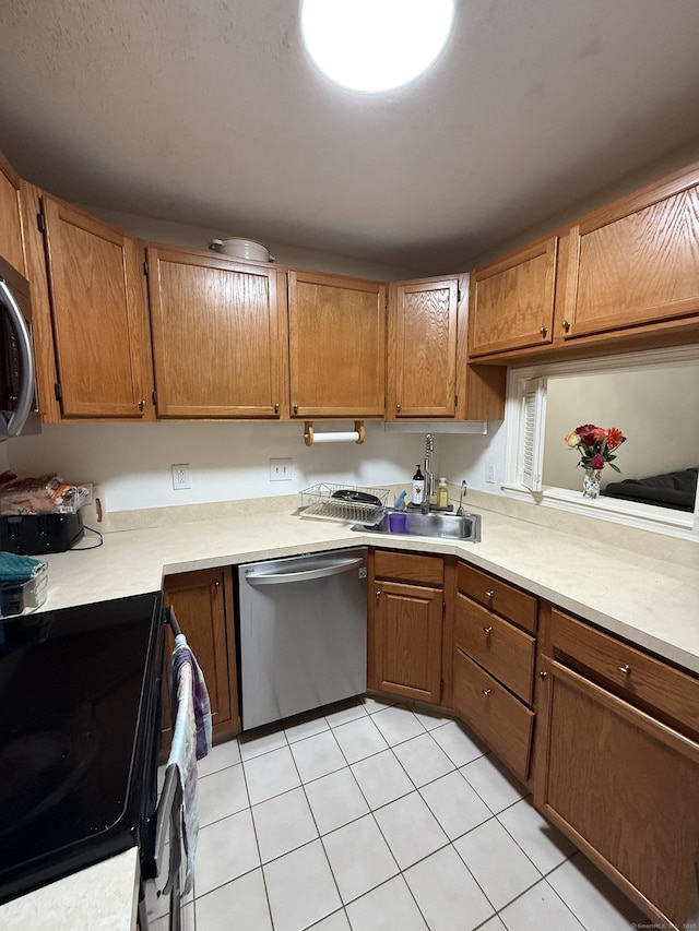401 Essex Ct Unit 401, Torrington, CT 06790 - kitchen with dishwasher, black range with electric stovetop, light countertops, brown cabinetry, and light tile patterned floors