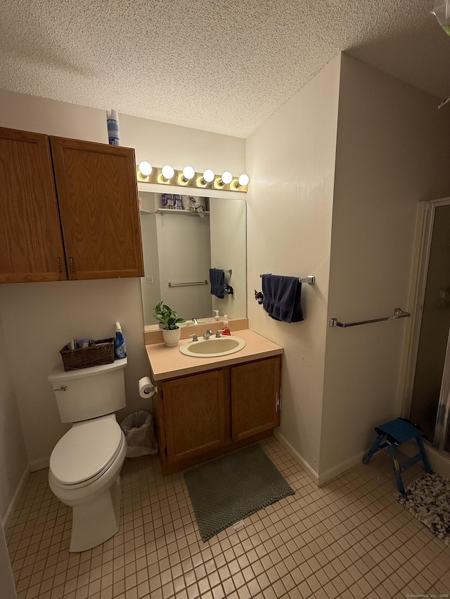 401 Essex Ct Unit 401, Torrington, CT 06790 - bathroom with a textured ceiling, vanity, tile patterned floors, and a stall shower