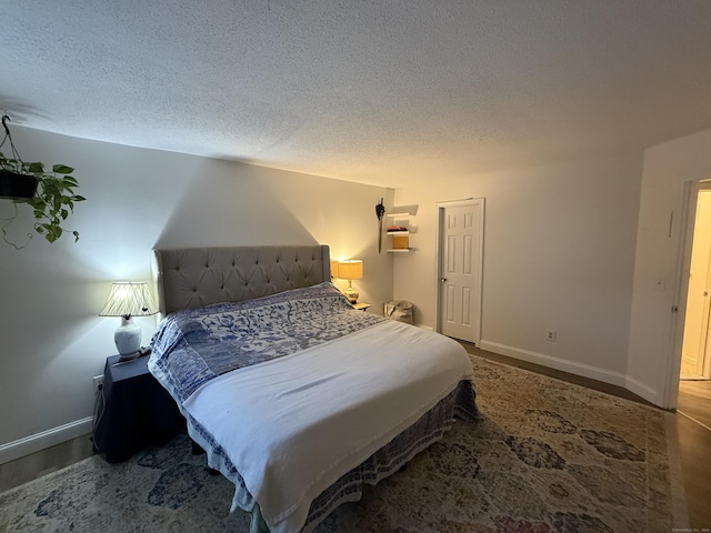 401 Essex Ct Unit 401, Torrington, CT 06790 - bedroom featuring a textured ceiling and wood finished floors