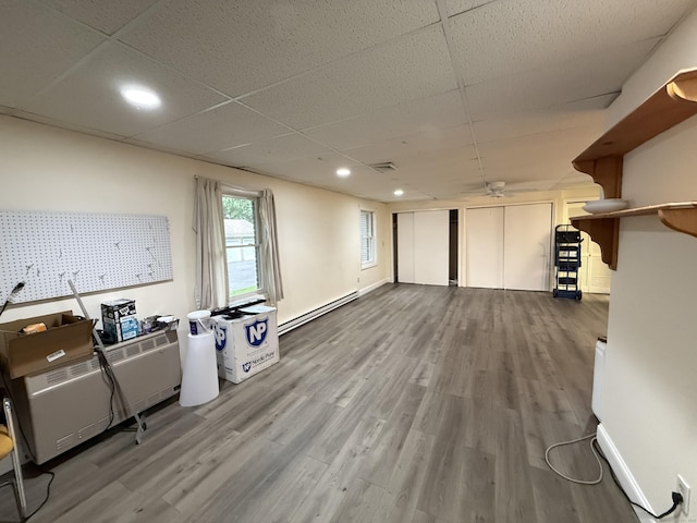 401 Essex Ct Unit 401, Torrington, CT 06790 - unfurnished living room featuring baseboard heating, wood finished floors, a paneled ceiling, recessed lighting, and ceiling fan