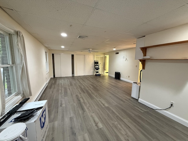 401 Essex Ct Unit 401, Torrington, CT 06790 - unfurnished living room featuring wood finished floors, a baseboard radiator, a paneled ceiling, and recessed lighting