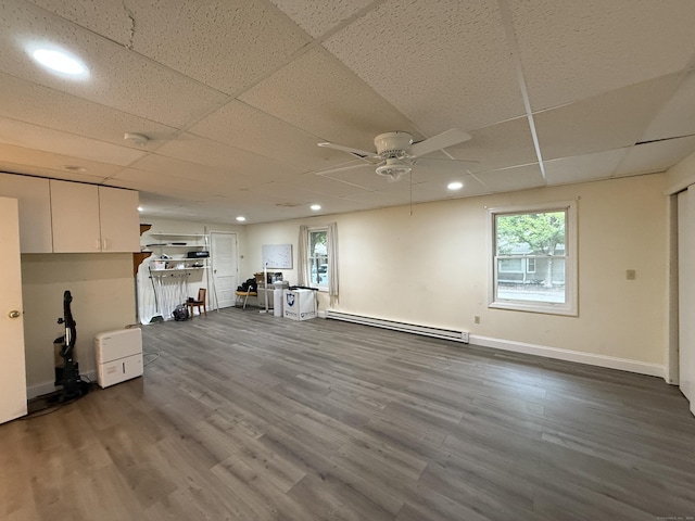 401 Essex Ct Unit 401, Torrington, CT 06790 - basement with a baseboard heating unit, a ceiling fan, dark wood-style floors, a drop ceiling, and recessed lighting