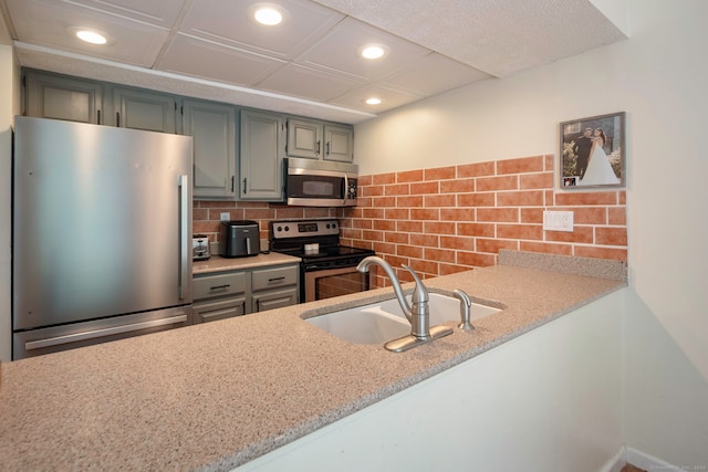 380 Hitchcock Rd Unit 227, Waterbury, CT 06705 - kitchen featuring stainless steel appliances, recessed lighting, tasteful backsplash, light stone counters, and gray cabinets