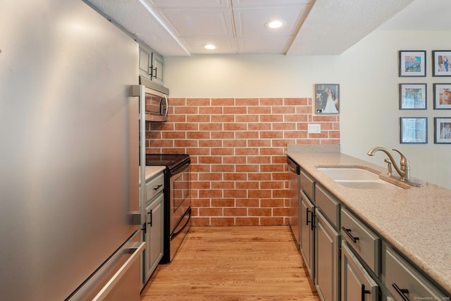 380 Hitchcock Rd Unit 227, Waterbury, CT 06705 - kitchen with appliances with stainless steel finishes, tile walls, recessed lighting, light wood finished floors, and a peninsula