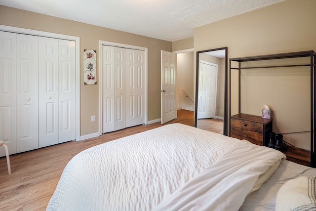 380 Hitchcock Rd Unit 227, Waterbury, CT 06705 - bedroom featuring multiple closets and light wood-style flooring