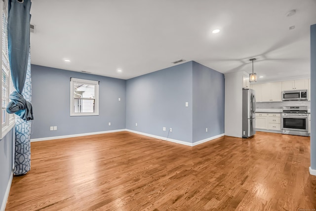 85 Floral Way, Stratford, CT 06615 - unfurnished living room featuring light wood finished floors and recessed lighting
