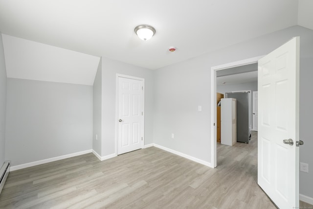 37 Martin St, Hartford, CT 06120 - additional living space with light wood-type flooring, a baseboard heating unit, and vaulted ceiling