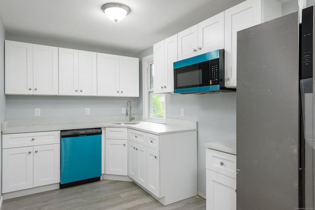 37 Martin St, Hartford, CT 06120 - kitchen featuring dishwasher, freestanding refrigerator, light wood-type flooring, light countertops, and white cabinets