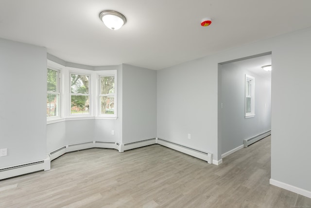 37 Martin St, Hartford, CT 06120 - empty room with a baseboard heating unit and light wood-type flooring