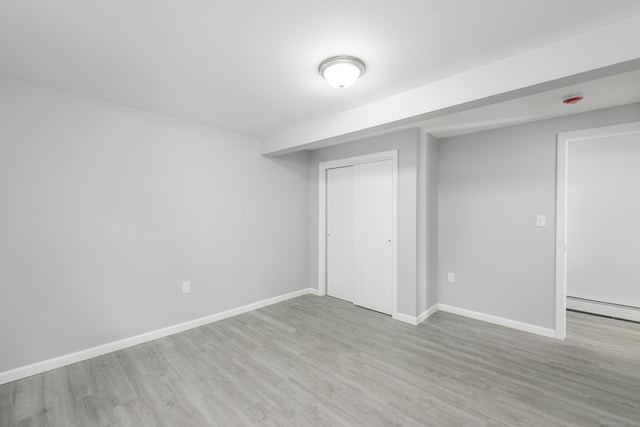 37 Martin St, Hartford, CT 06120 - unfurnished bedroom with wood finished floors, a closet, and a baseboard radiator